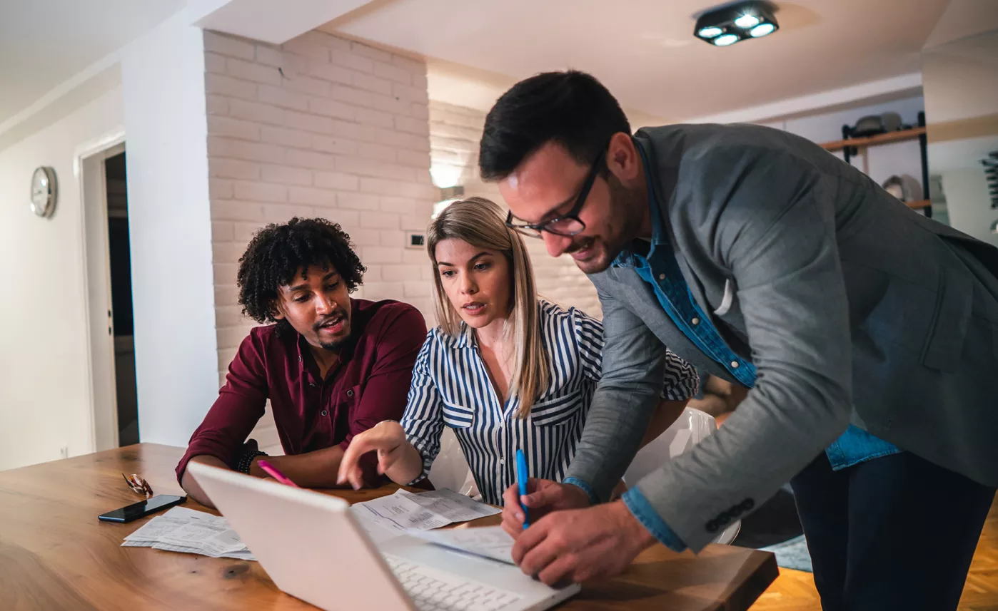  An Edward Jones financial advisor helps two client with their financial portfolio.
