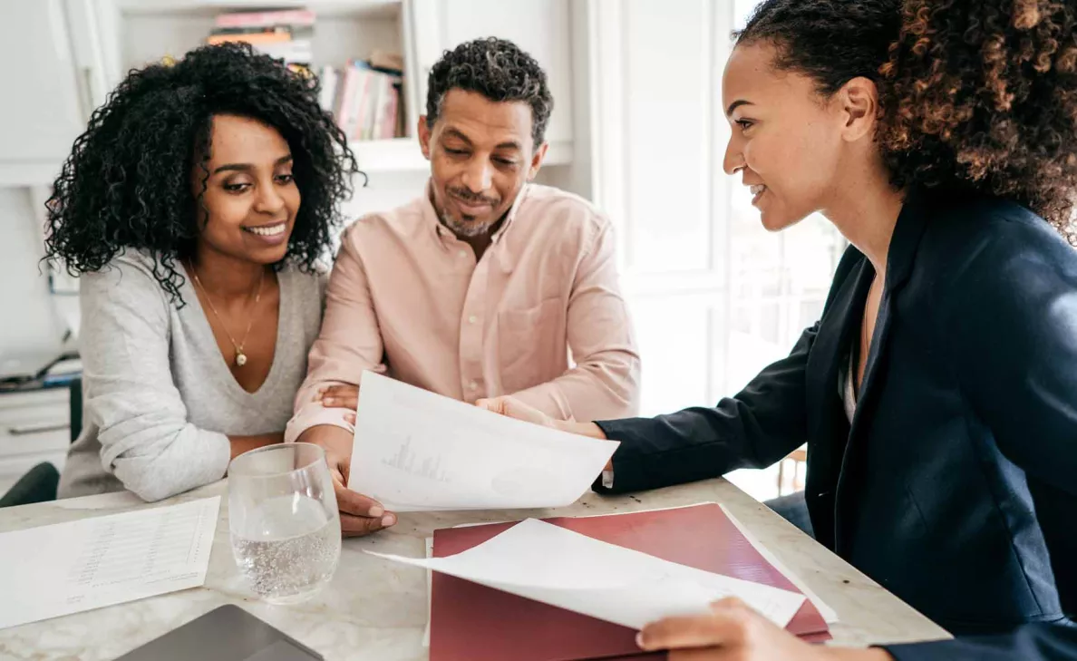  Man and woman meeting with financial advisor.
