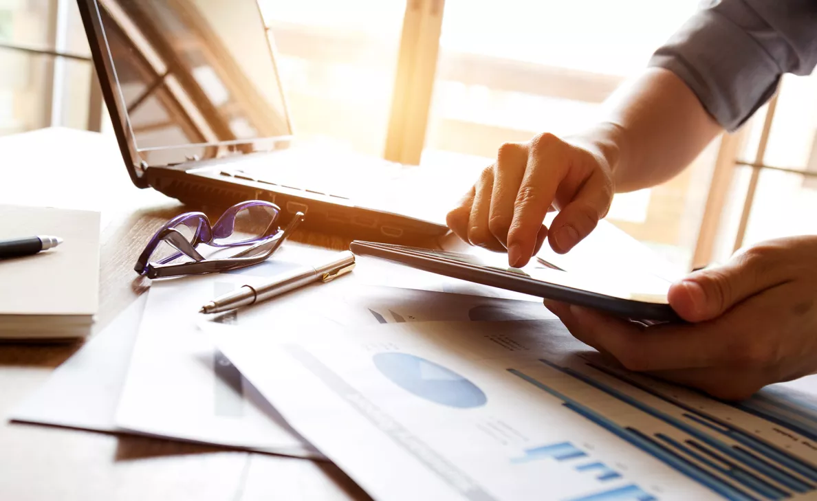  An Edward Jones client reviews reports and data on mutual funds, before he makes an educated decision.
