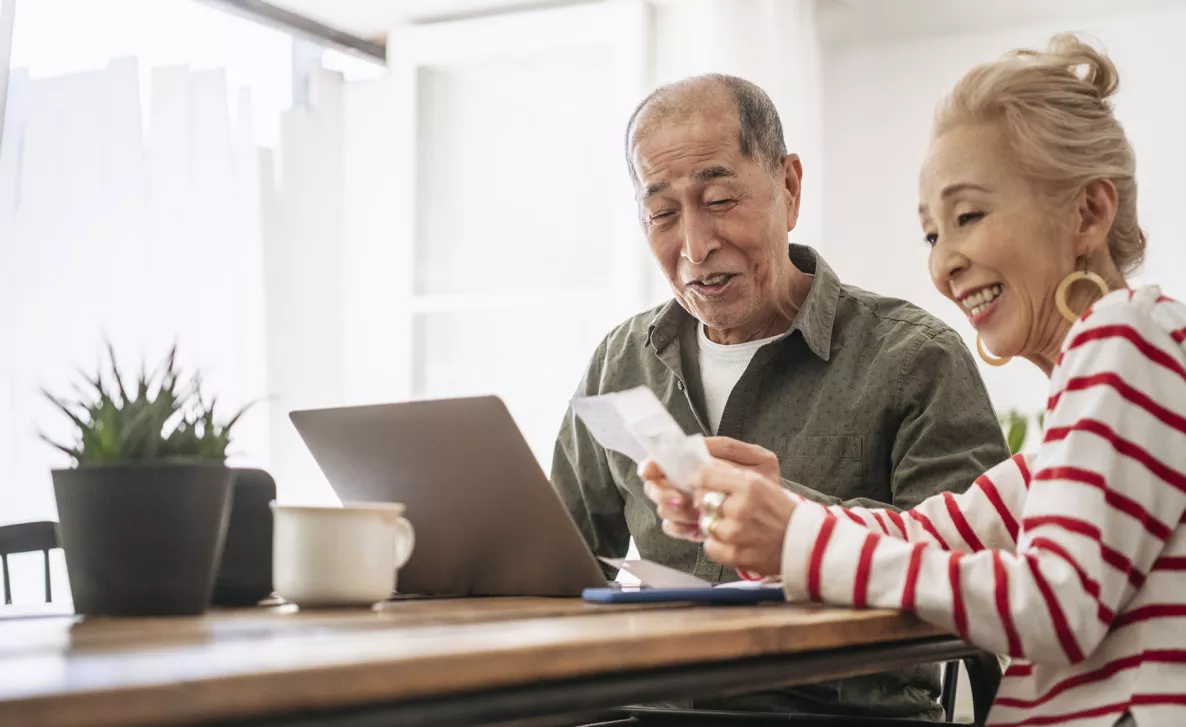  Couple at home looking at laptop
