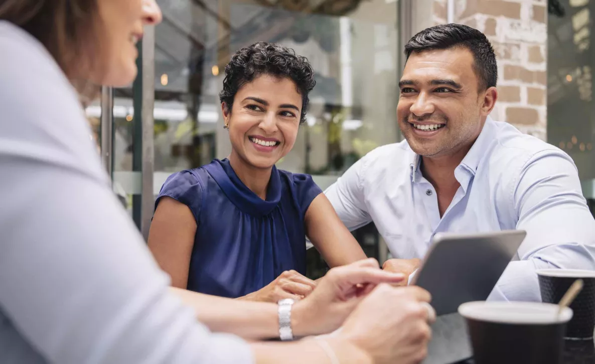  An Edward Jones advisor consults two clients on their financial options.
