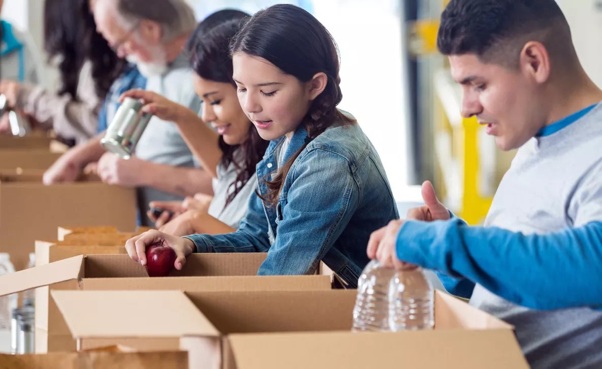  Children packing boxes at food pantry
