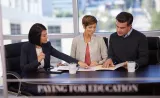 An Edward Jones financial advisor discusses investments with two client in her office.