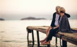 Couple sitting along riverside